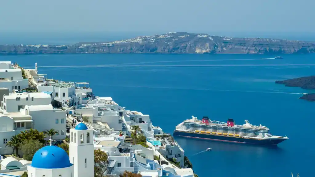 Best way to see Europe without rushing with a Mediterranean cruise ship sailing past Santorini’s white cliffside village