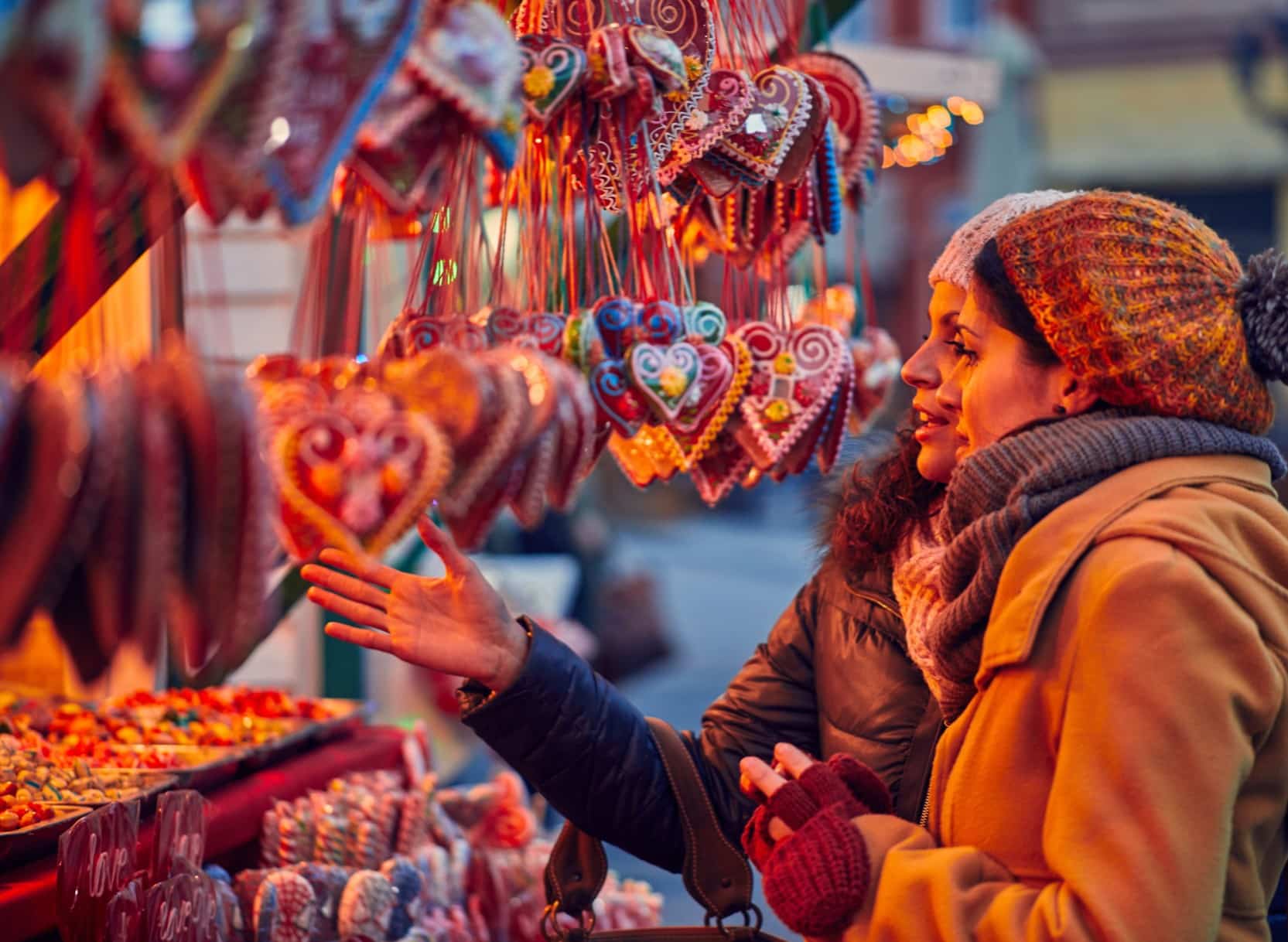 Luxury European river cruise excursion at a Christmas market with travelers exploring local food and handmade gifts