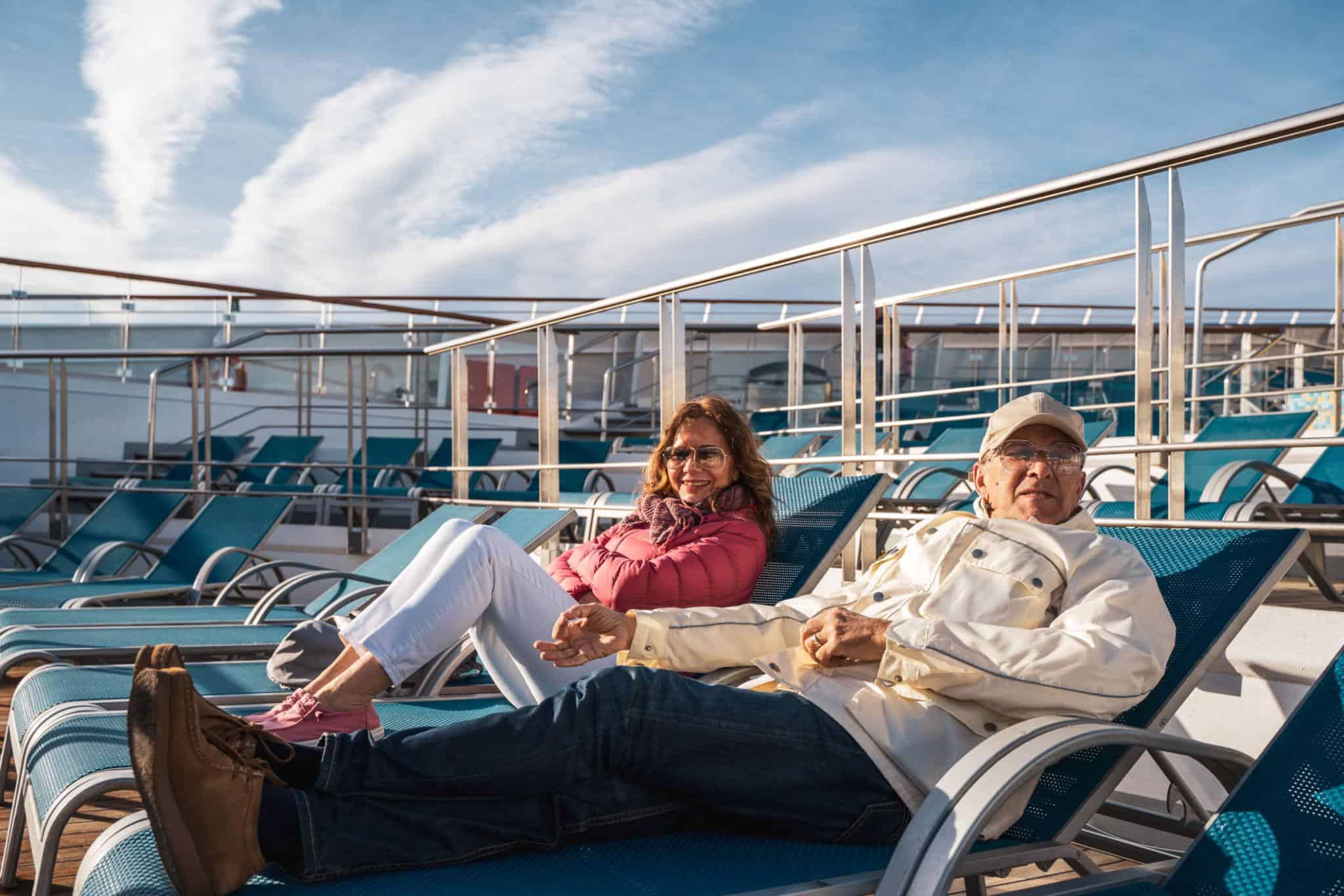 first-time cruisers relaxing on a cruise ship deck enjoying ocean views
