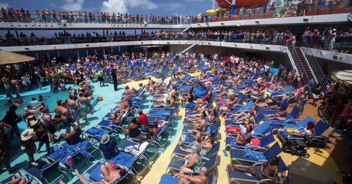 Large cruise ship crowded public areas with passengers waiting in lines