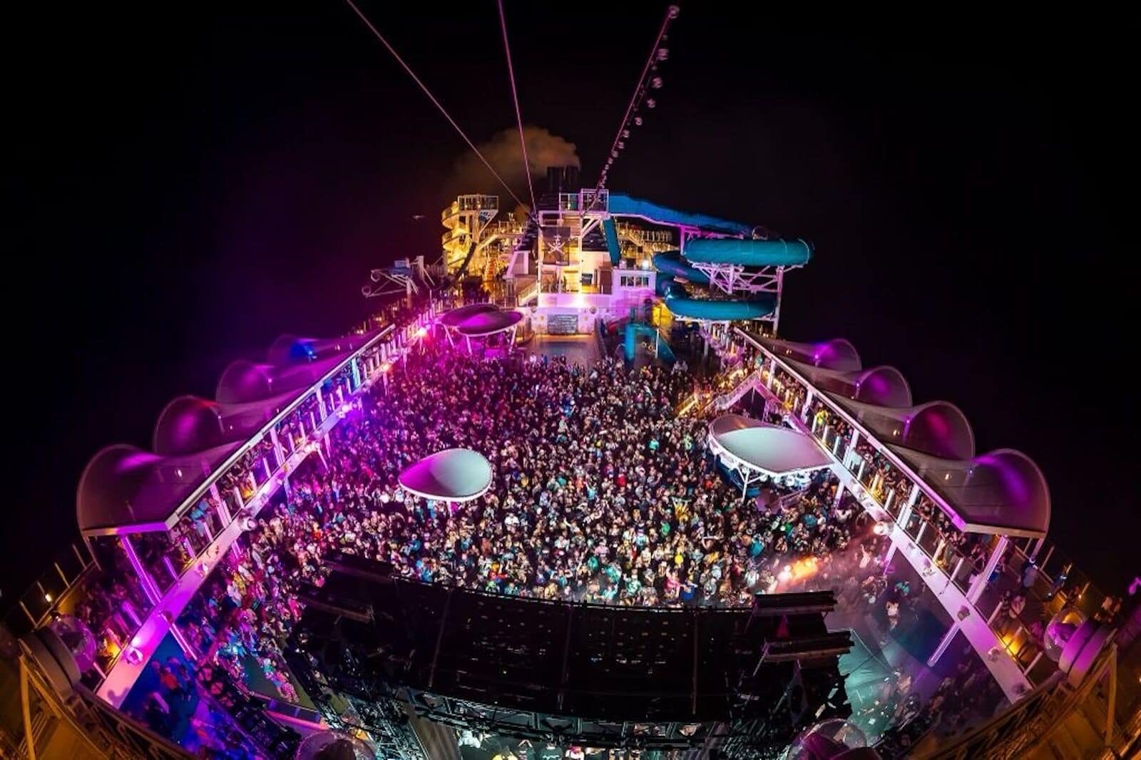Large cruise ship entertainment show with stage lighting and audience