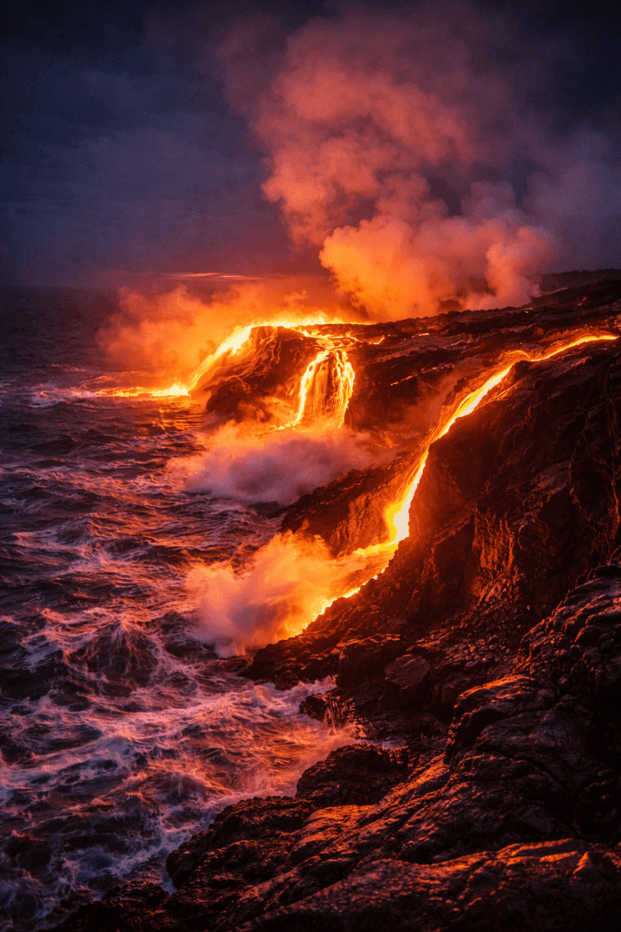 Glowing red lava flow from Kilauea volcano entering the ocean at night in Hawaii Volcanoes National Park on the Big Island of Hawaii