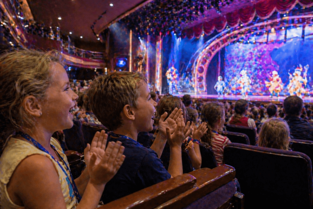 Children laughing and enjoying live entertainment on a Disney cruise ship