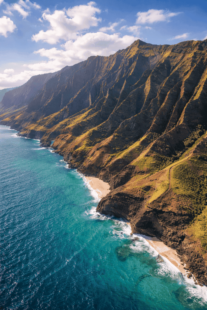 Dramatic Na Pali Coast sea cliffs rising from turquoise water on the north shore of Kauai, Hawaii, viewed from a boat tour
