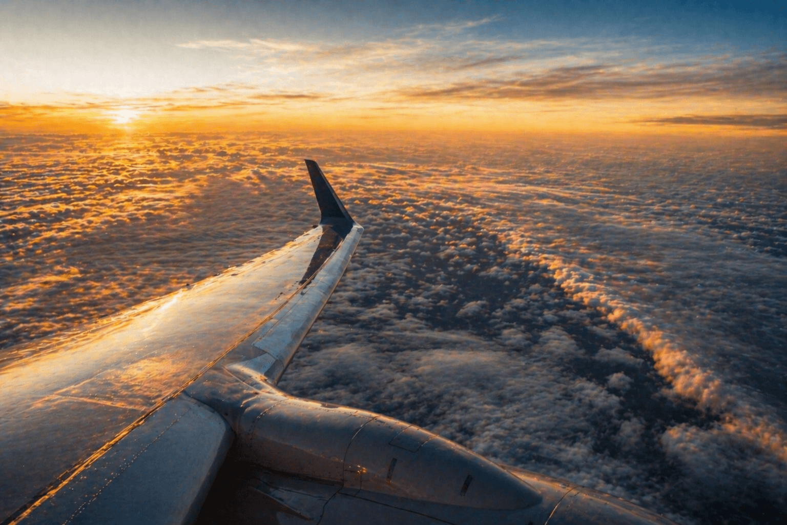 View from airplane window above the clouds on a transatlantic flight to Europe.