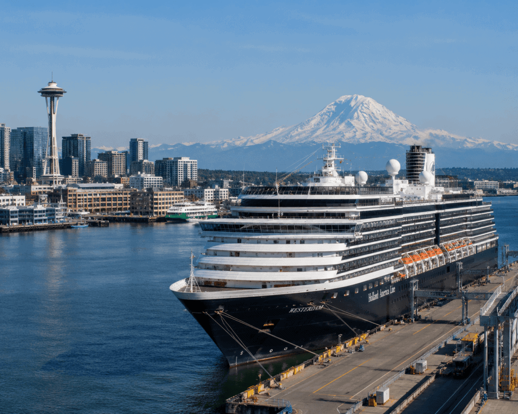 Alaska cruise ship departing from Seattle with snow-capped mountains visible in background