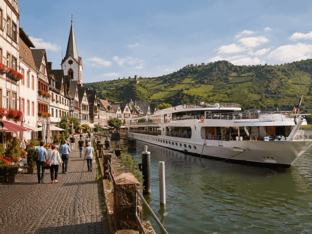 River cruise ship docked at a European town with cobblestone streets — what to wear on a river cruise in Europe