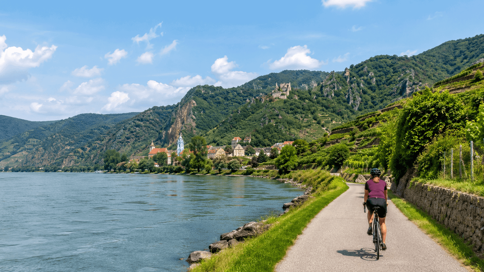 Cyclist on a riverside path through the Wachau Valley on an active European river cruise