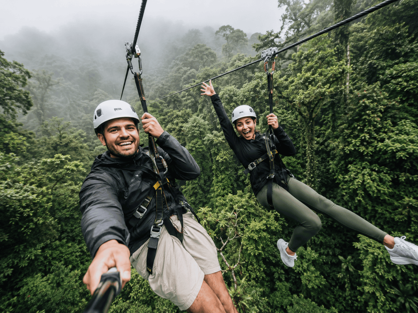Couple zip-lining through the Monteverde Cloud Forest in Costa Rica on an active honeymoon