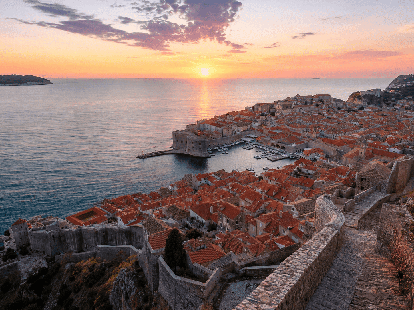 Dubrovnik Croatia city walls at sunrise with the Adriatic Sea and old town rooftops below