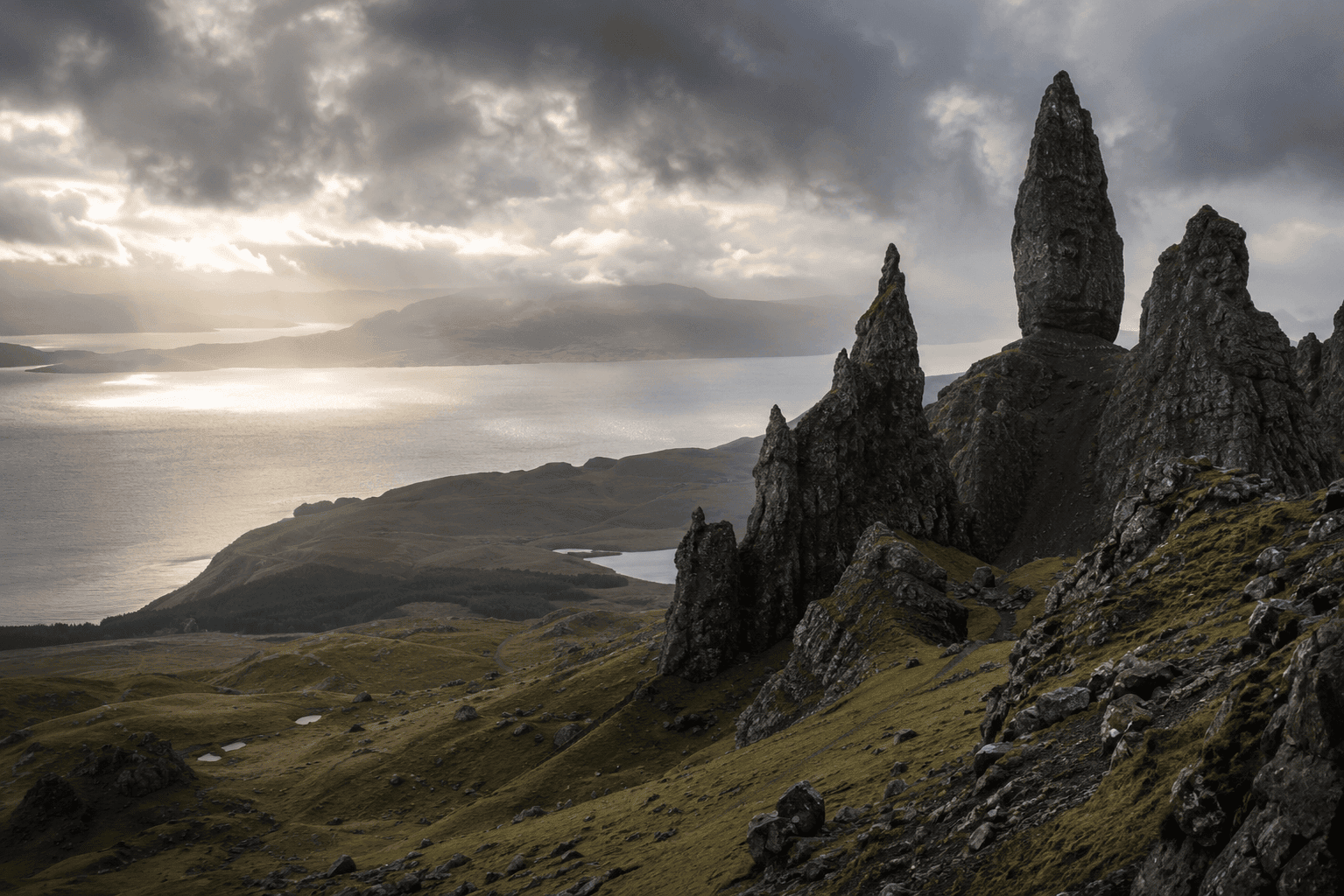 Couple hiking near the Old Man of Storr on the Isle of Skye, Scotland, a top non-beach honeymoon destination for outdoorsy couples