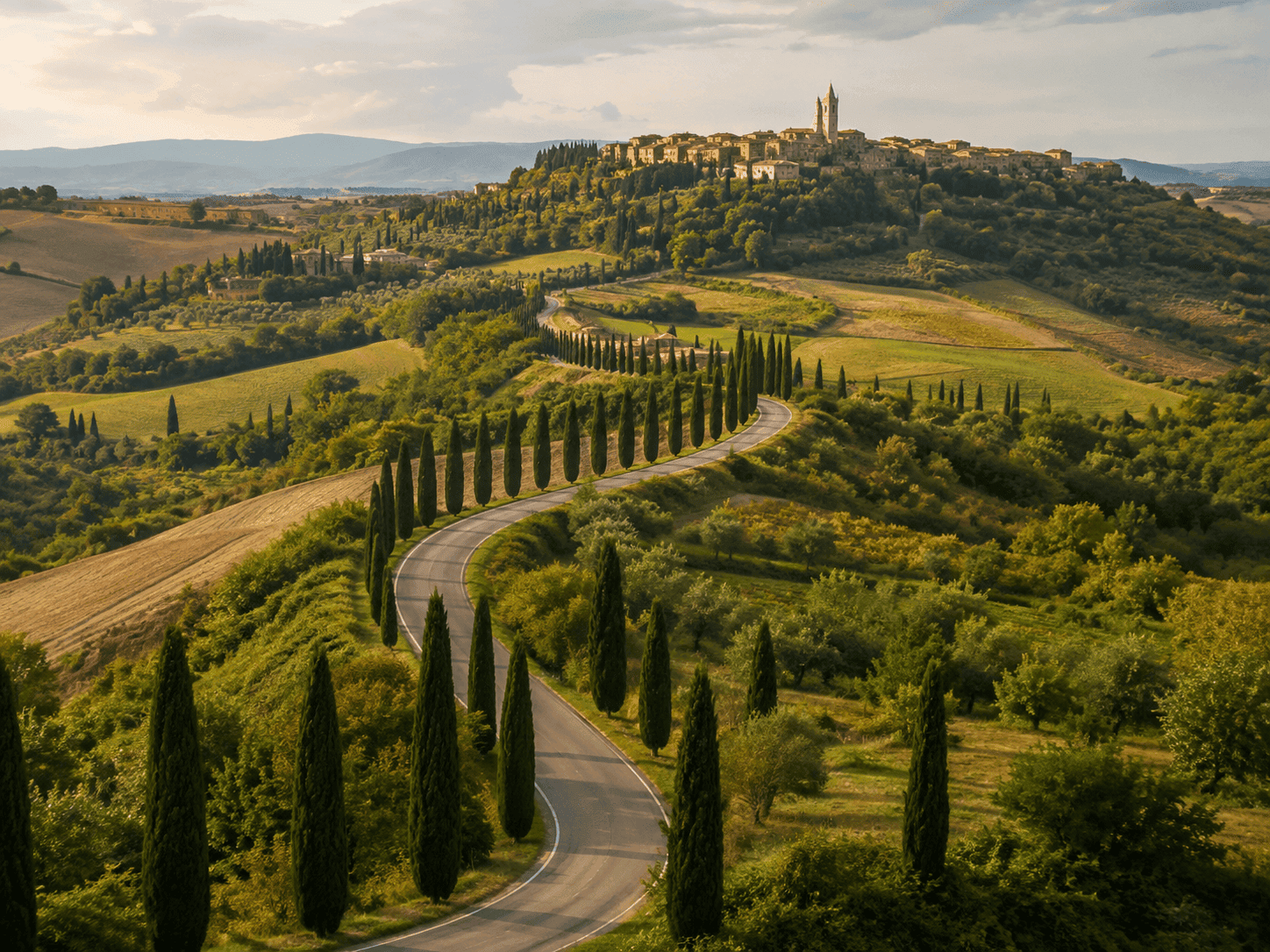 Cypress-lined road winding through Tuscan hills near a stone village, a stop on Italy tour packages 2027