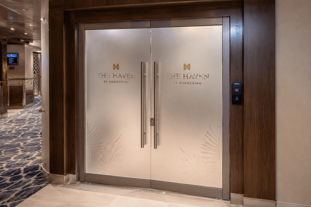 Keycard access entrance doors to The Haven by Norwegian on a cruise ship deck