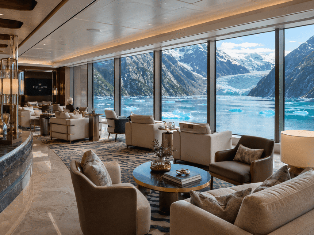 NCL Haven observation lounge with floor to ceiling windows overlooking an Alaska glacier
