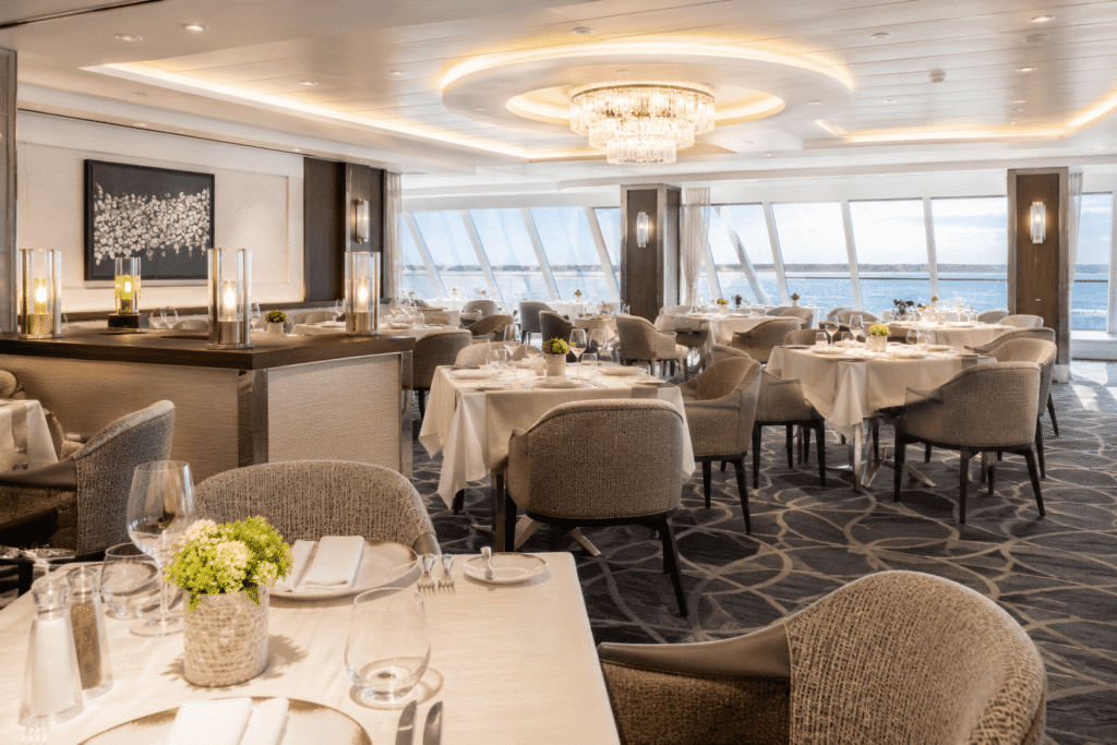 The Haven Restaurant interior with set dining tables on a Norwegian Cruise Line ship