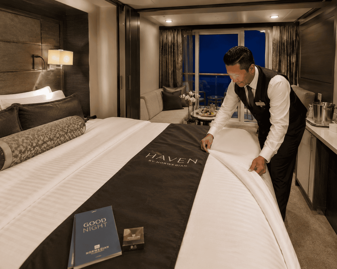Stateroom steward completing turndown service in an NCL Haven suite
