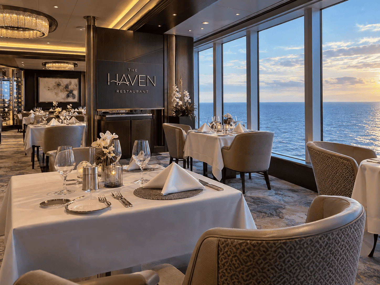 The Haven Restaurant on deck 18 of Norwegian Encore, set with white tablecloths and window seating